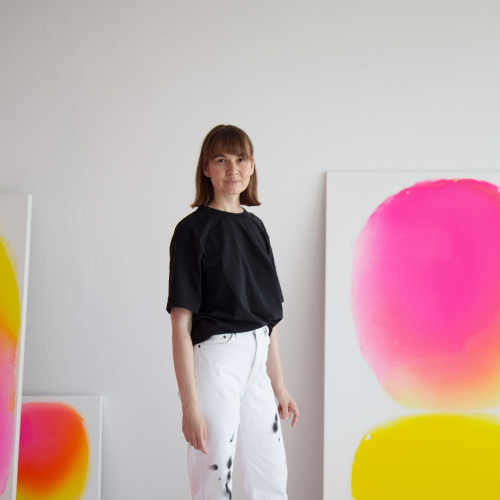 Profile picture of the artist Dasha Buben with some of her art